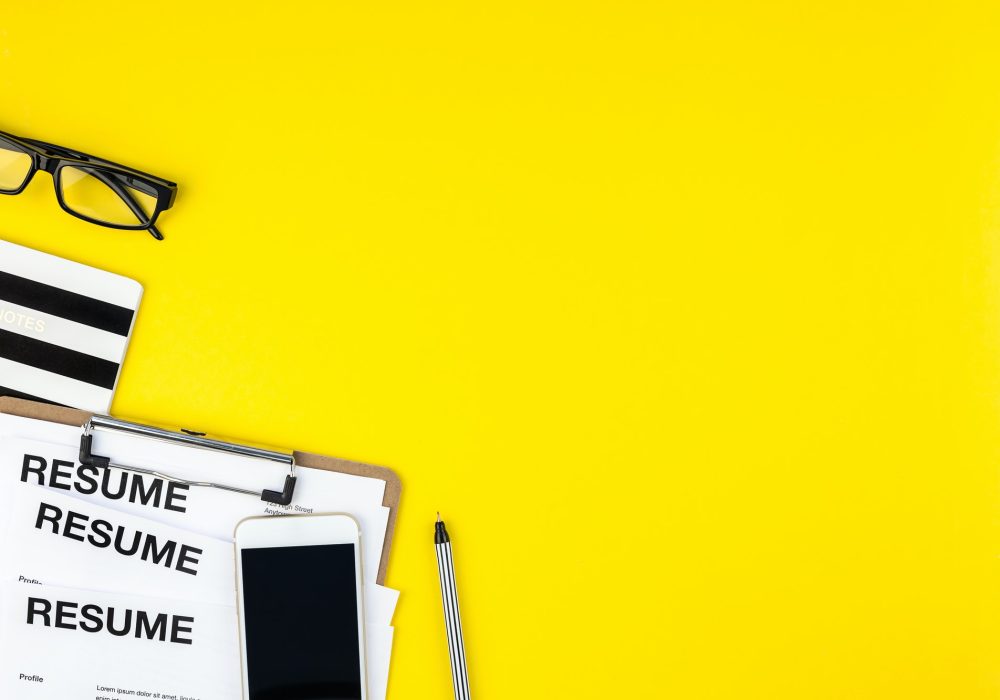 We are hiring flat lay on yellow background